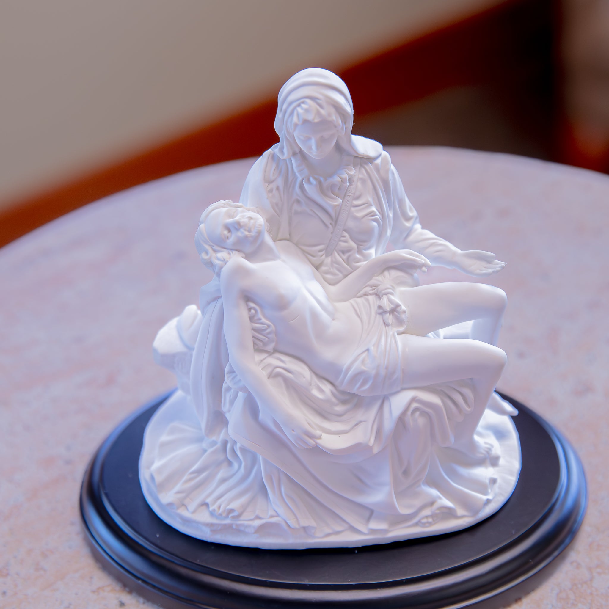White Pieta Statue on a Black Base